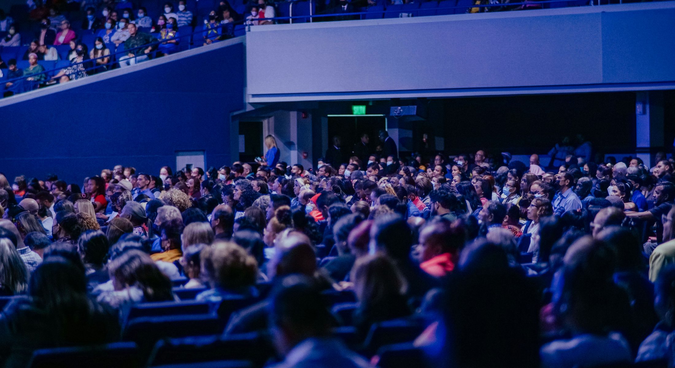 A large conference audience watching a presentation